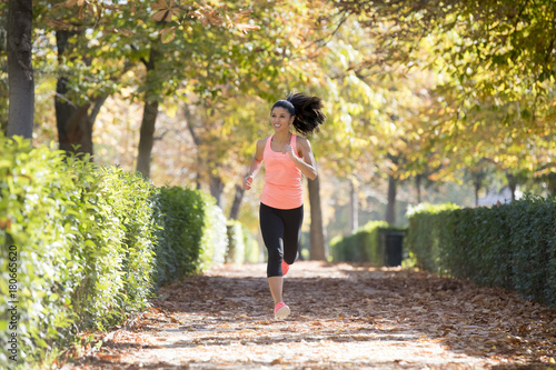 attractive and happy runner woman in Autumn sportswear running a © Wordley Calvo Stock