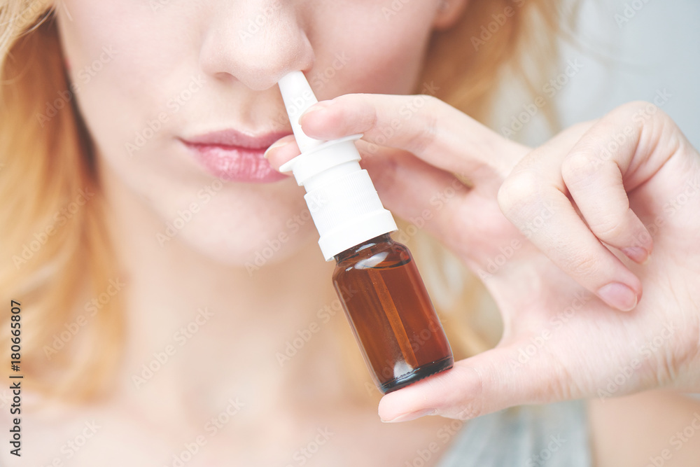 The treatment of rhinitis. Girl dripping nose drops The treatment of rhinitis. Girl dripping nose drops