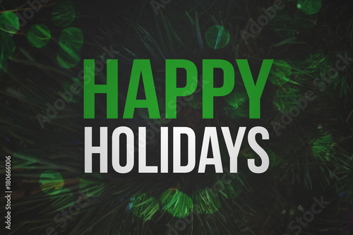 Happy Holidays Text with Pine Branches Background and Green Bokeh Lights