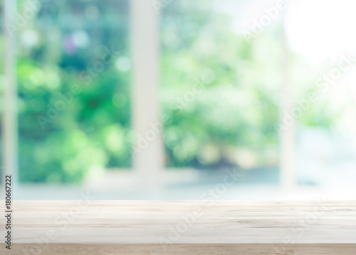 Wood table top on blur of window with garden flower background in morning.For montage product display or key visual layout