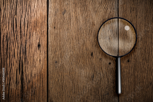 magnifying glass on old vintage ground wooden texture floor background