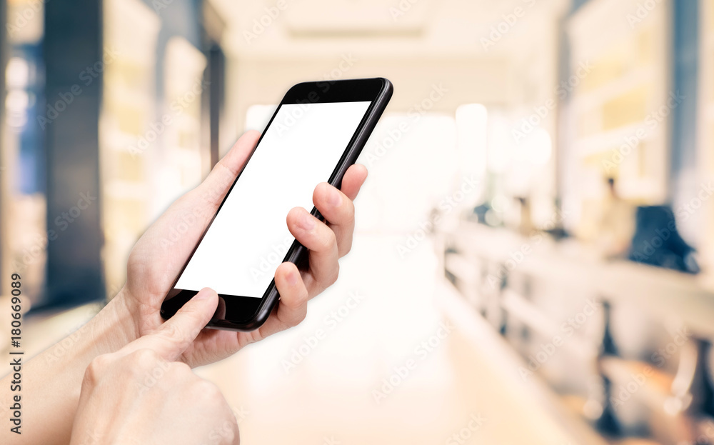 Hand click mobile phone with blur office corridor hall way background bokeh light,White screen mock up template for adding your design or your text