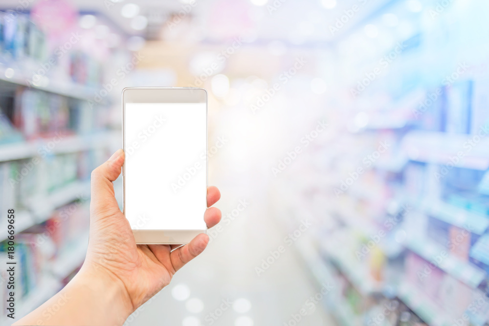 blur image background of supermarket in shopping mall with hand hold blank screen smartphone for your text blur image background of supermarket in shopping mall with hand hold blank screen smartphone for your text