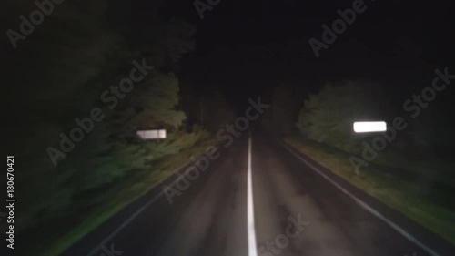 night road through a thick scary forest. shooting from the car on the track. car driving forward. Shooting from a double-decker bus. 4k