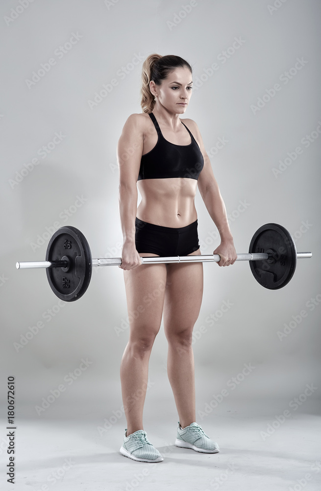 Woman doing barbell rows Woman doing barbell rows