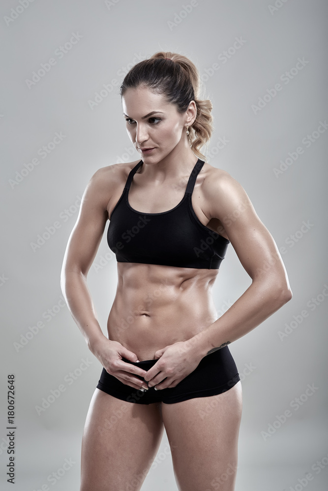 Fototapeta premium Fitness woman posing in gym outfit