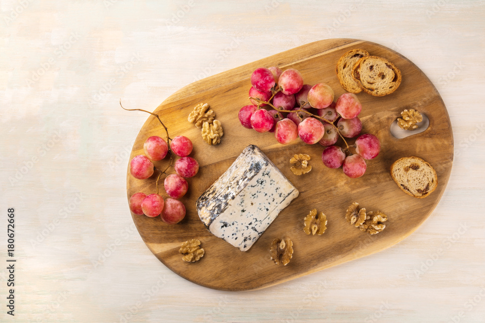 Blue cheese with grapes, nuts, and toasts, and copyspace