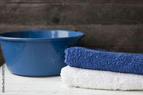 Obraz na plátne two towels and a basin on the table on wooden background