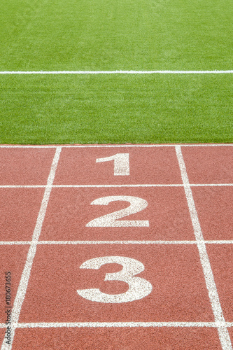 The numbers 1,2,3 on race track in football stadium.