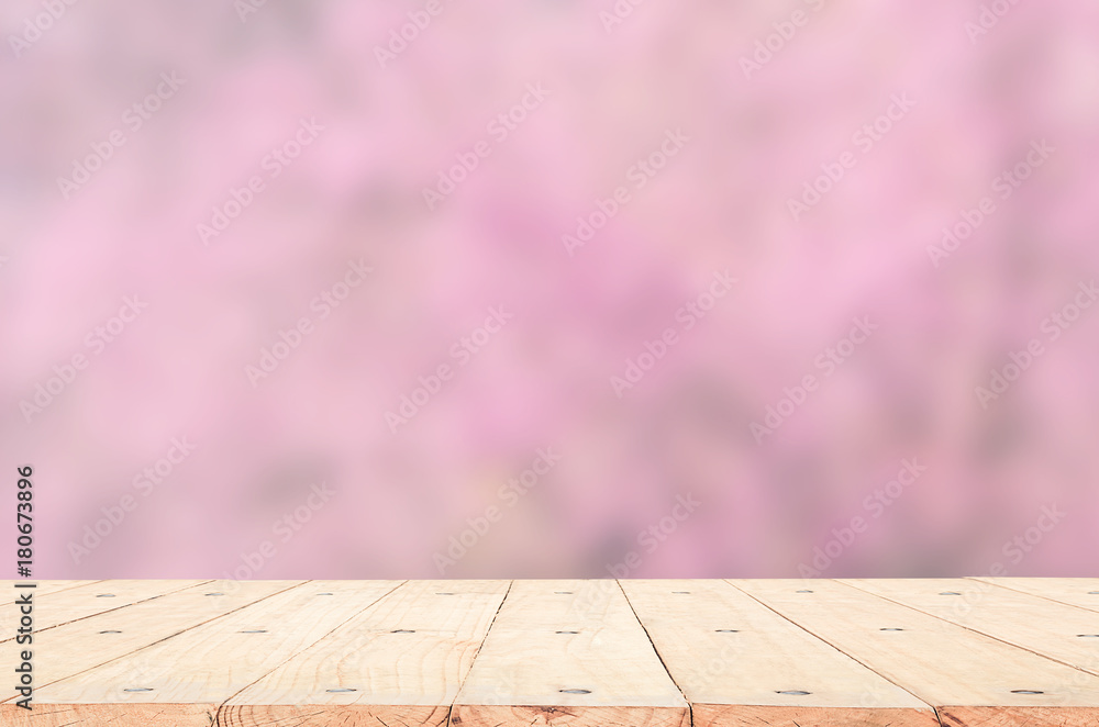 wood table top on blurred background of pink cherry blossom flower. the background for product display template wood table top on blurred background of pink cherry blossom flower. the background for product display template