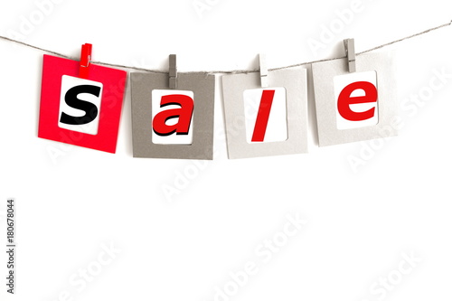 Clip cloths with sale word card hanging on rope isolated on white background © waller
