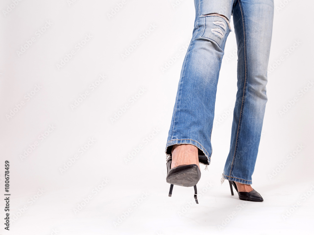Fashion girl in high heel shoes and denim jeans. Isolated on a White Background. Fashion girl in high heel shoes and denim jeans. Isolated on a White Background.