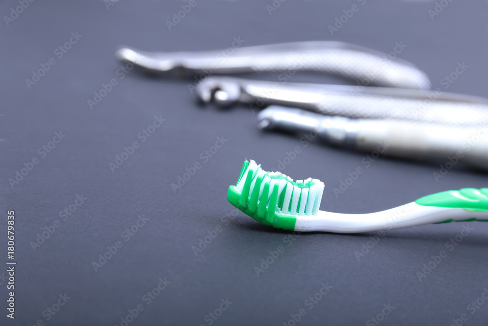 dental care toothbrush with dentist tools on black background. dental care toothbrush with dentist tools on black background.