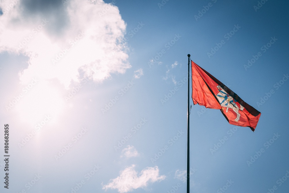 The coat of arms of Lithuania. Knight on a horse on a red background. Blue sky.