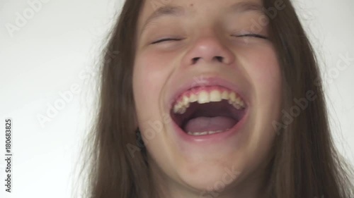 Beautiful happy teenage girl is surprised and laughing close-up on white background stock footage video