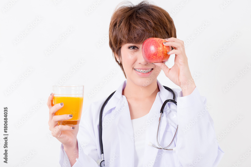 Happy woman doctor holding the red heart and orange juice. Isolated on white background. Studio lighting. Concept for healthy and medical Happy woman doctor holding the red heart and orange juice. Isolated on white background. Studio lighting. Concept for healthy and medical