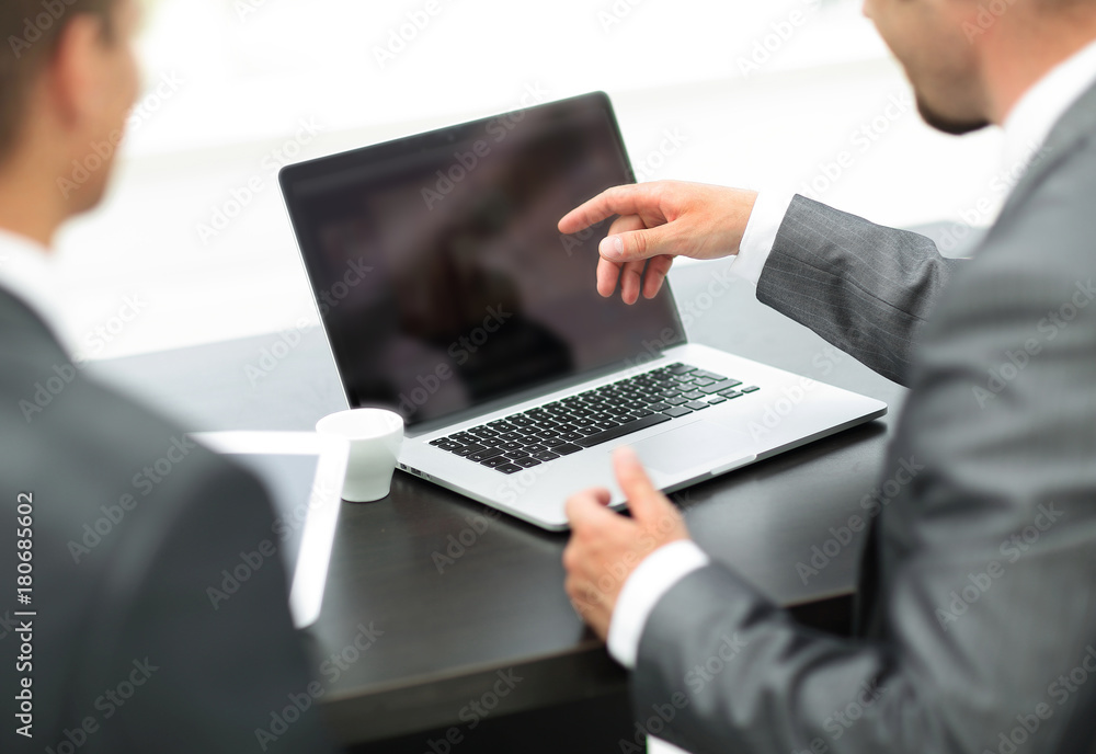 closeup. business colleagues discussing information with a laptop. closeup. business colleagues discussing information with a laptop.
