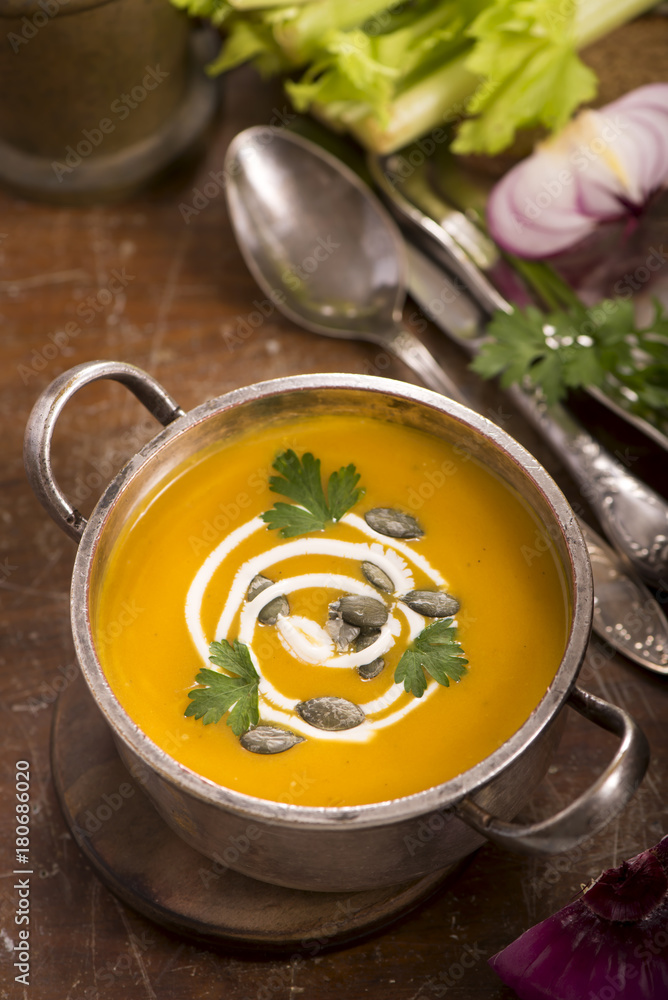 pumpkin soup on rustic wooden background pumpkin soup on rustic wooden background