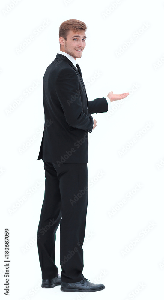 rear view.smiling businessman pointing forward. photo in full growth. rear view.smiling businessman pointing forward. photo in full growth.
