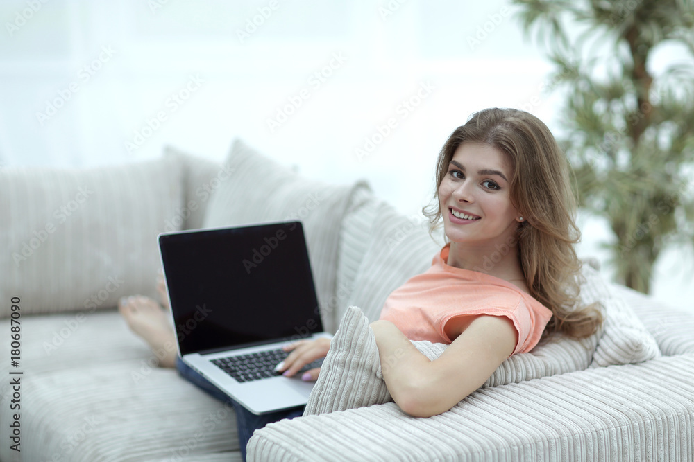 young woman working with laptop sitting in the living room young woman working with laptop sitting in the living room