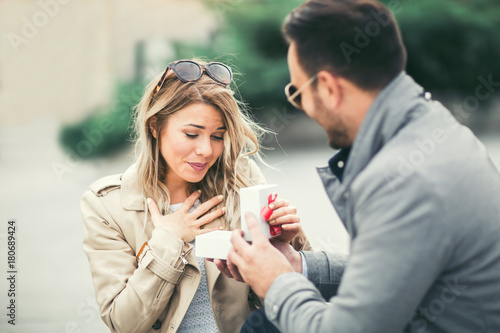 Slika na platnu Couple in love.Man surprising his girlfriend with a gift.