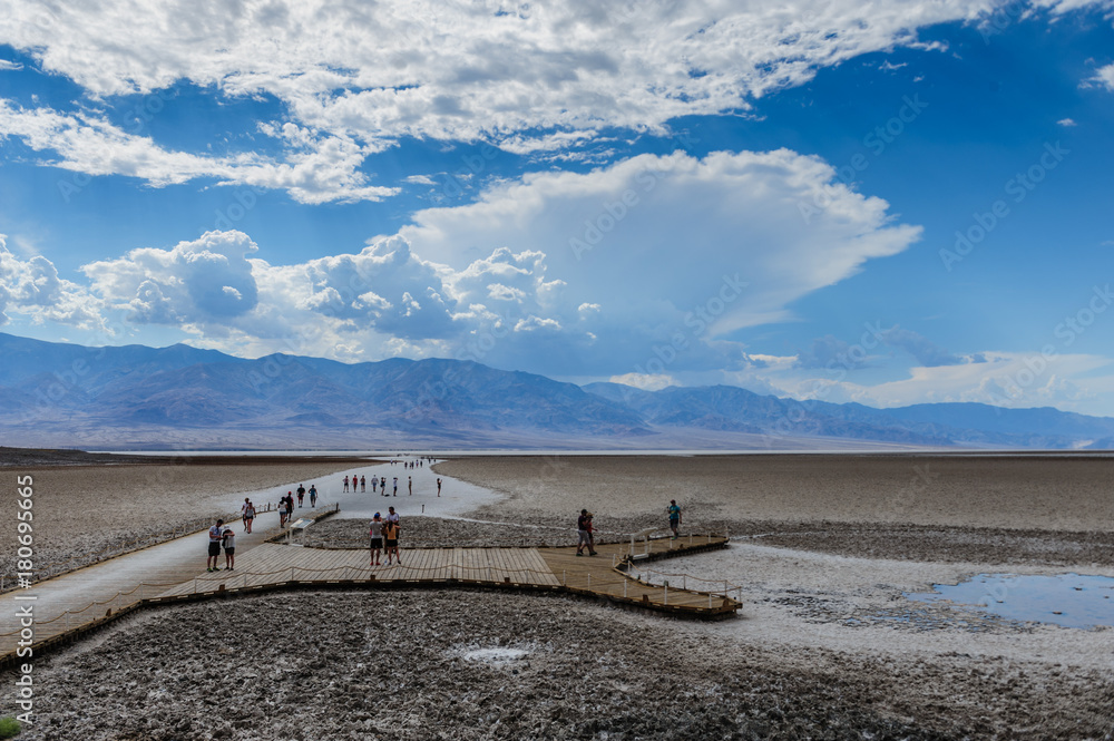 Tourists walking on a salt flats of Badwater