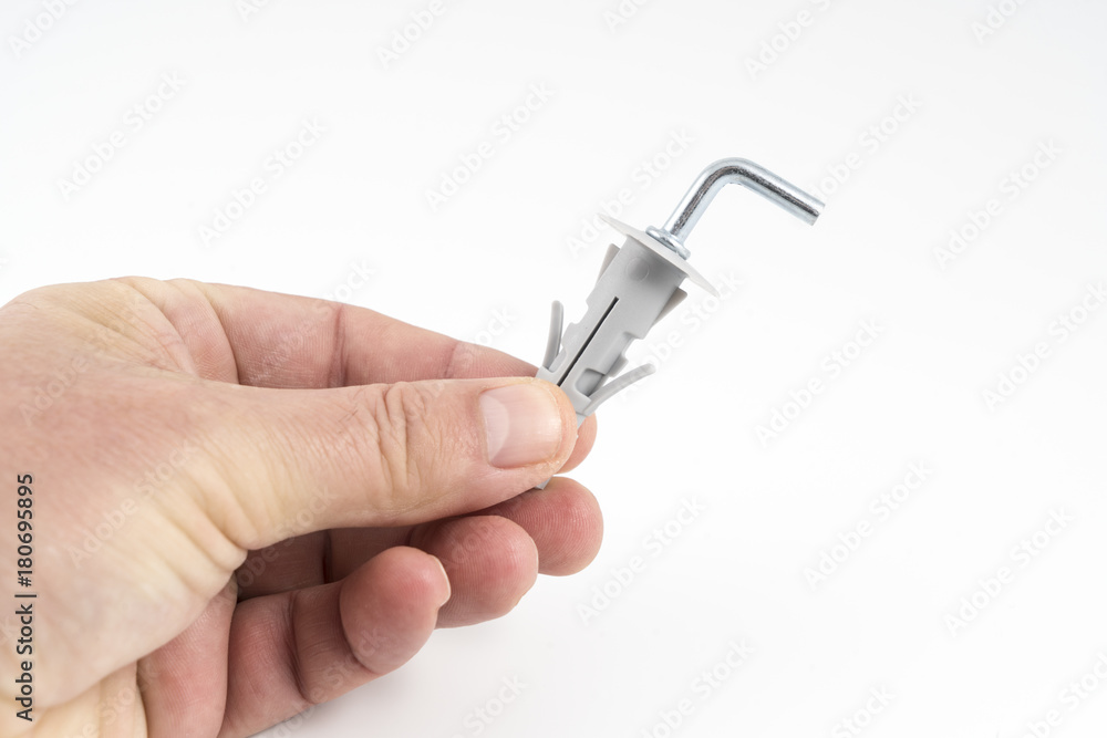 a metal clip with the plastic plug between the fingers a metal clip with the plastic plug between the fingers