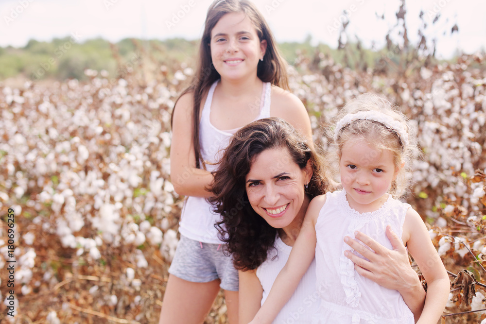 Portrait of beautiful mother with two daughters outdoors Portrait of beautiful mother with two daughters outdoors