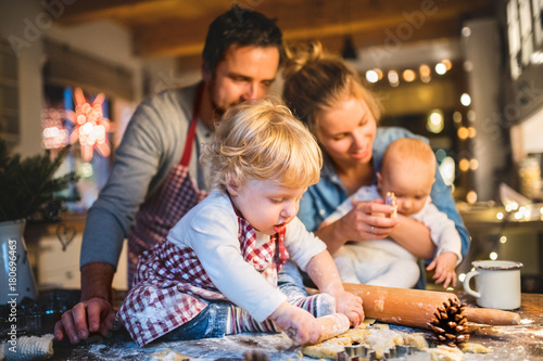 Young family making cookies at home.