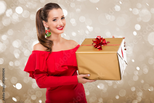 Beautiful santa Woman holding a gift box