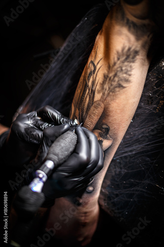 Tattoo artist doing tattoos