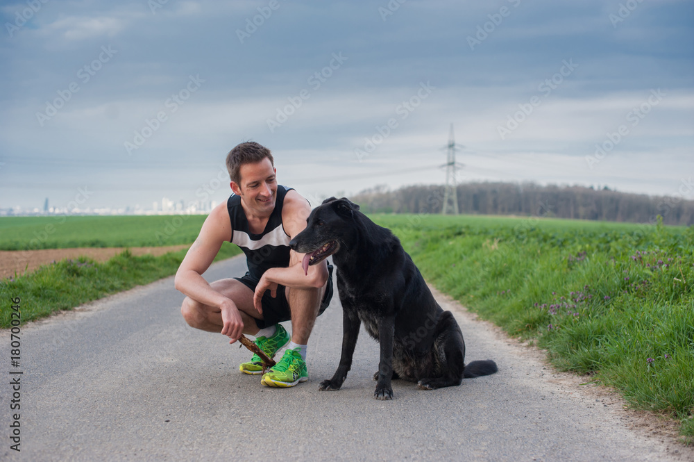Young man with a dog on the road Young man with a dog on the road