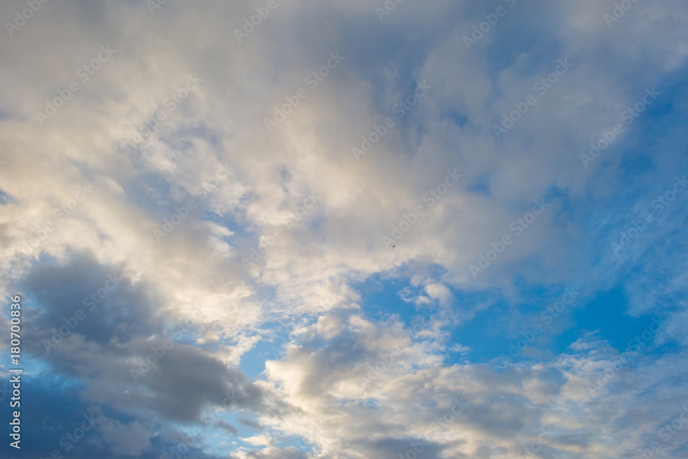 Clouds in a blue sky in sunlight at fall