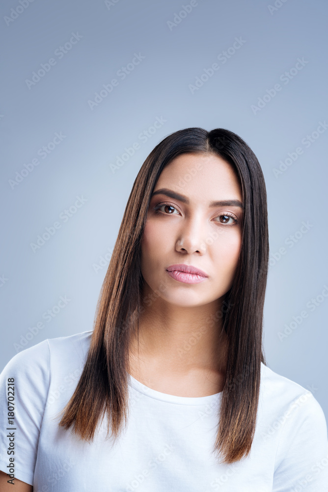 Strict woman. Young elegant beautiful woman making an impression of a strict angry person while standing calmly and looking into the distance Strict woman. Young elegant beautiful woman making an impression of a strict angry person while standing calmly and looking into the distance
