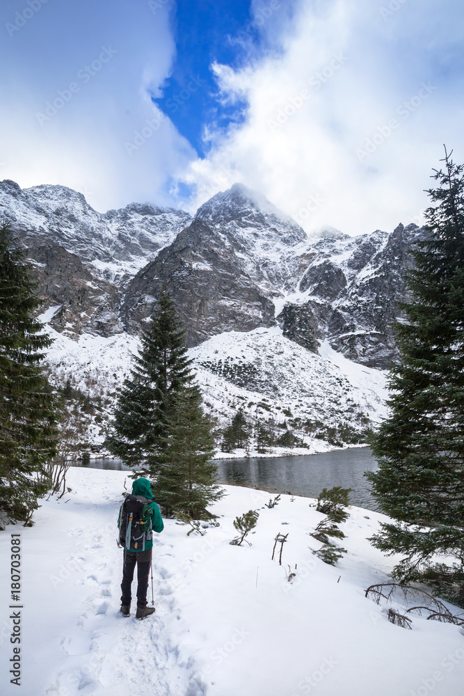Man with backpack trekking in Tatra mountains, Poland