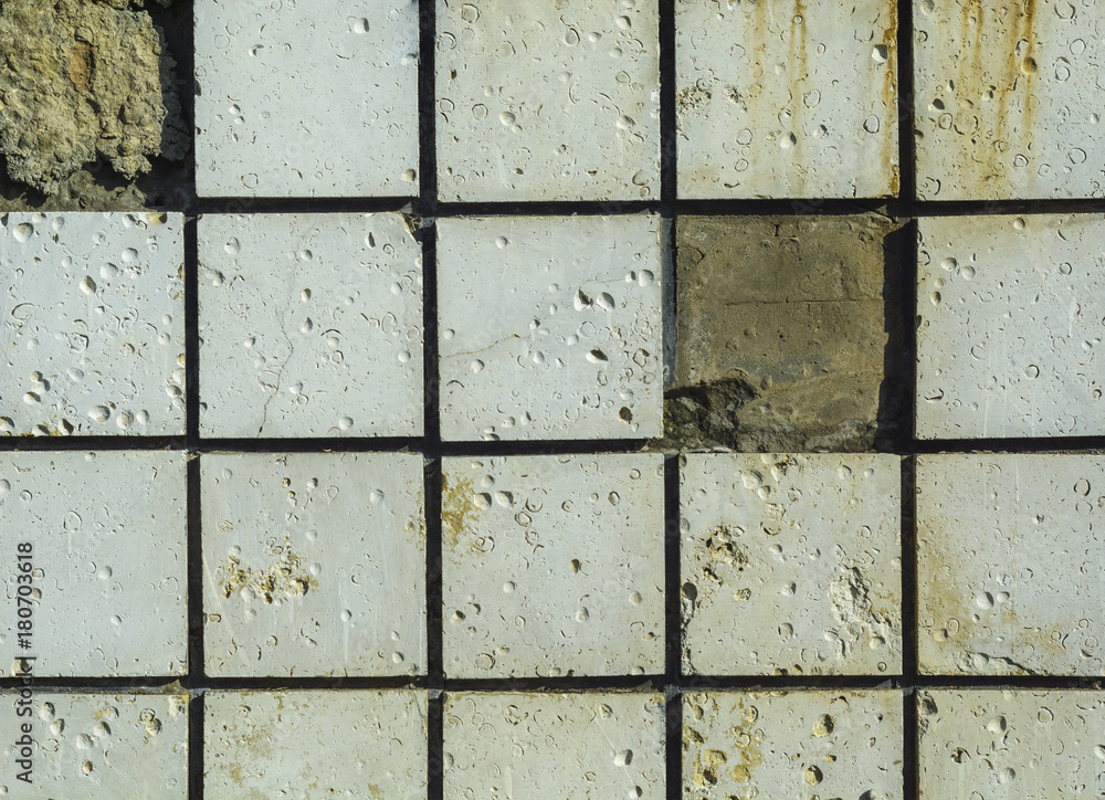 Naklejka premium Stone wall with concret briks , one brick is missing.