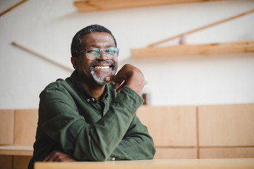 happy mature man in cafe