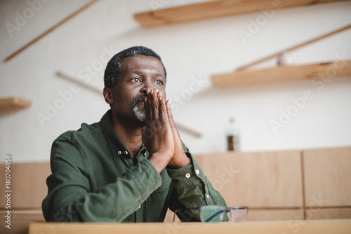 thoughtful mature man sitting in cafe photo