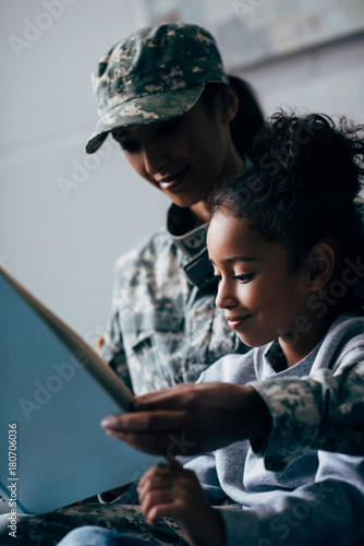 daughter and soldier reading book