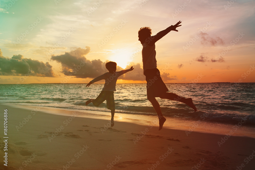 Fototapeta premium father and little son enjoy sunset beach
