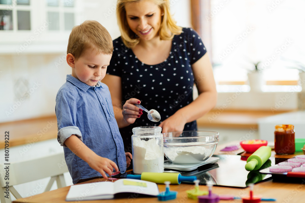 Mother and child preparing cookies Mother and child preparing cookies
