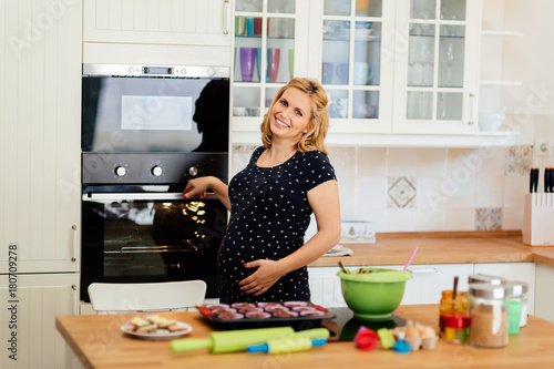 Beautiful woman in kitchen preparing cookies