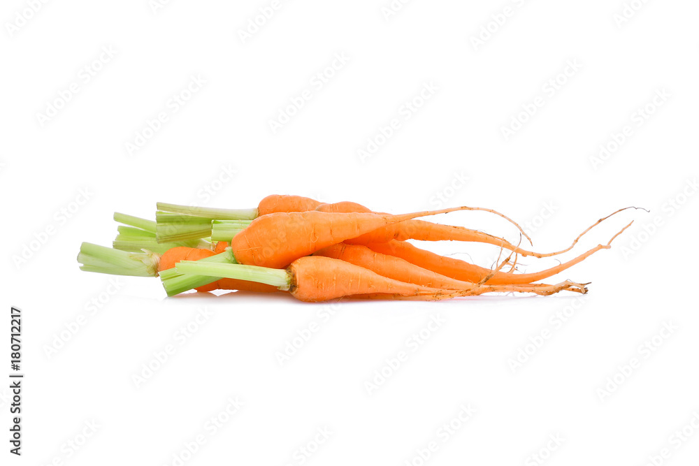 pile of baby carrots with root isolated on white background