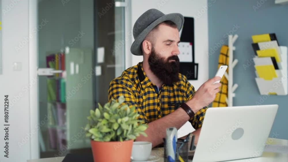 Man using a smart phone and a computer Man using a smart phone and a computer