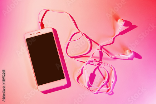 Mobile phone (smartphone) and earphones © pinkyone