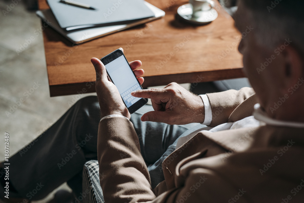 Fototapeta premium Businessman Typing on Cell Phone