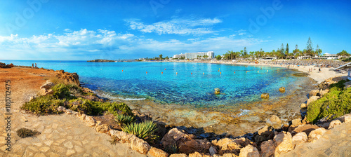 Fototapeta Naklejka Na Ścianę i Meble -  View of turquoise water Nissi beach in Aiya Napa, Cyprus. Ayia Napa coastline. Beautiful sand beach in Aiya Napa, Cyprus. Famous tourist beach in Cyprus
