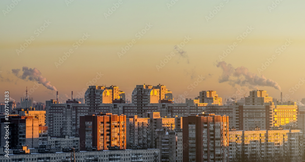 Residential arrays of high-rise buildings on the horizon sunset.