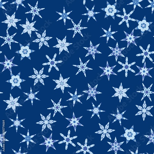 Seamless pattern with abstract colorful snowflakes on blue background. Chaotic, random, scattered winter motives. Vector illustration.