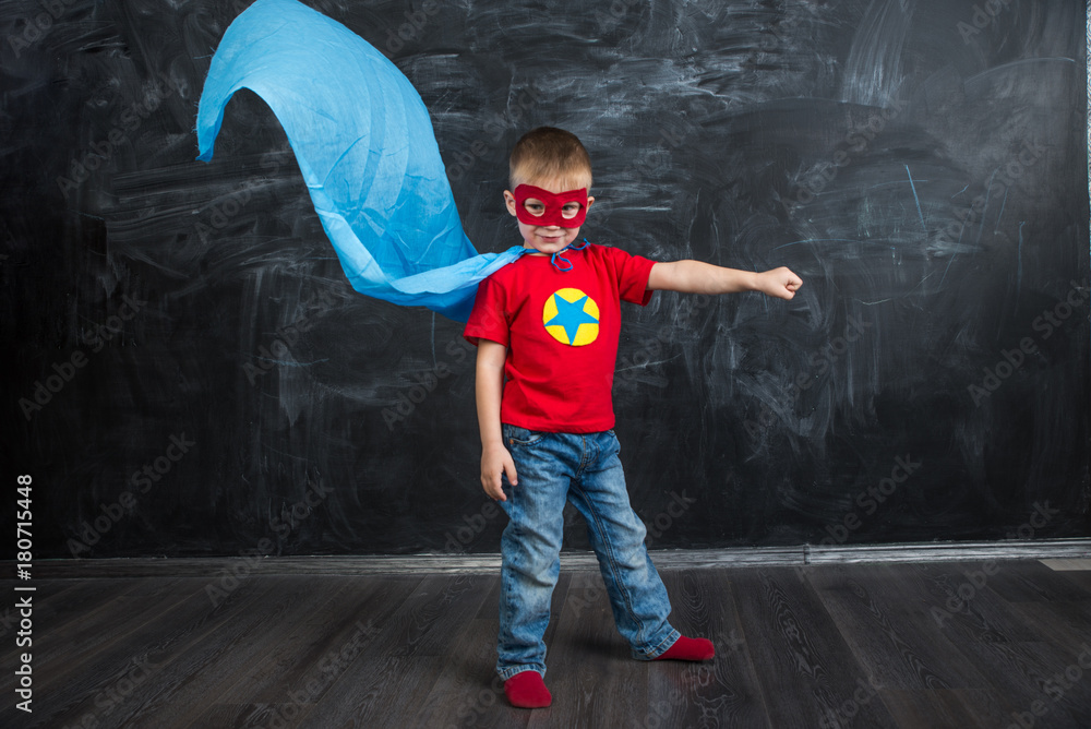 boy superhero in a blue Cape red mask and a red t-shirt with a star